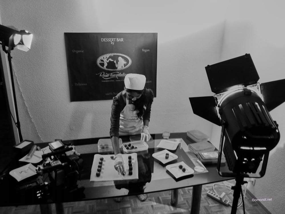 Candice preparing pralines under studio lights for a filmed cooking segment
